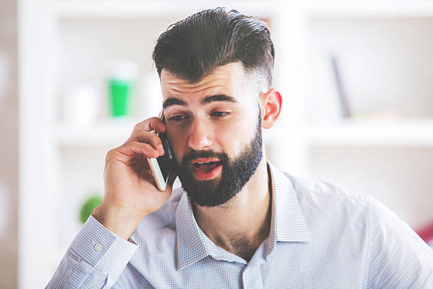 Excited man talking on phone stock photo