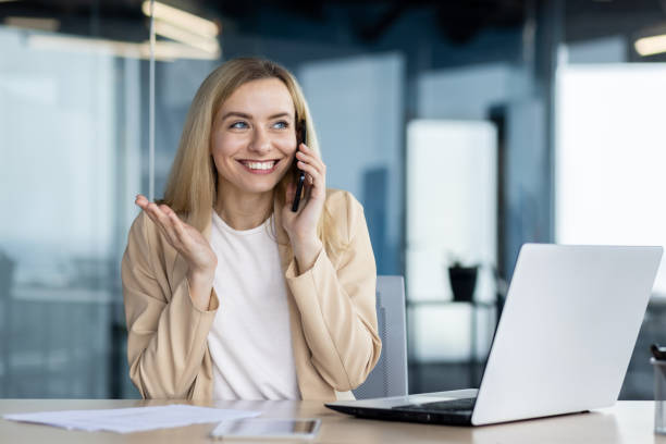 Professional woman smiling while talking on phone in office